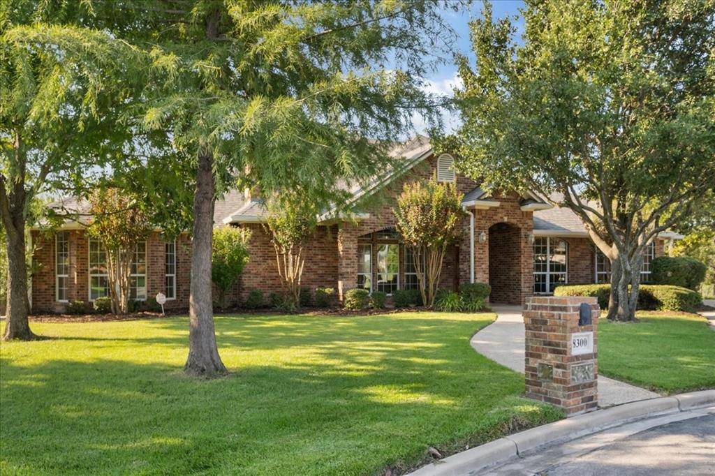 8300 Jonquil Drive Waco, TX 76708 - Photo 3 of 40 a view of a house with a big yard and large trees