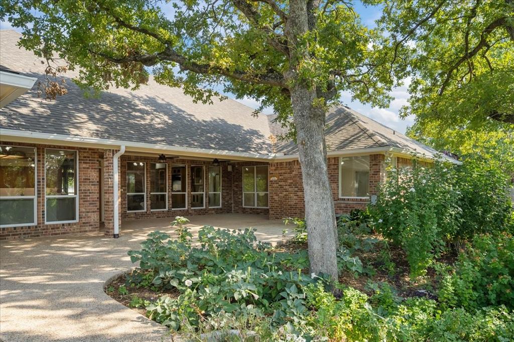 8300 Jonquil Drive Waco, TX 76708 - Photo 33 of 40 front view of a house with a tree in front of it