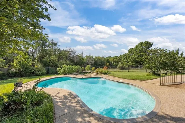 a view of a swimming pool with a yard