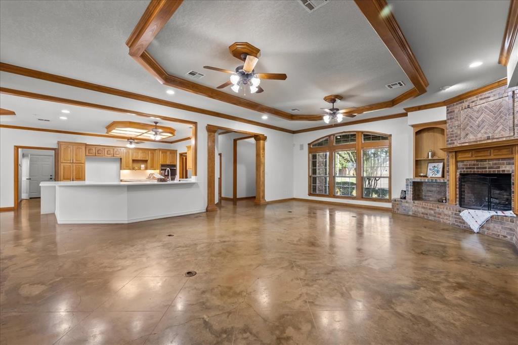 8300 Jonquil Drive Waco, TX 76708 - Photo 6 of 40 a view of an empty room with a fireplace and chandelier