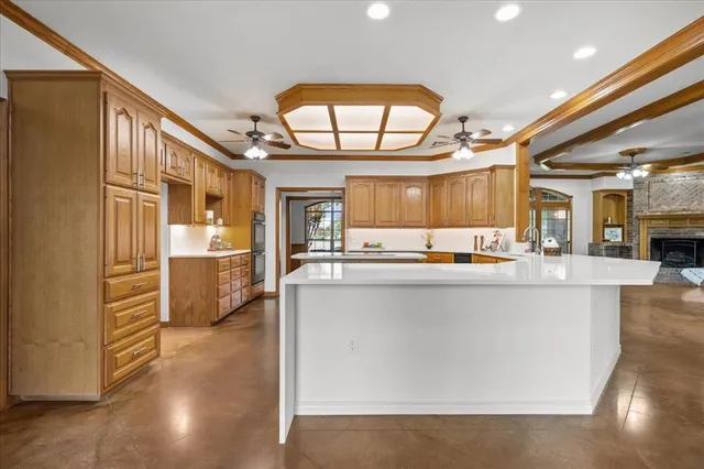 a large kitchen with a large counter top appliances and cabinets
