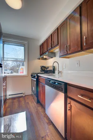 a kitchen with stainless steel appliances granite countertop a sink stove and cabinets