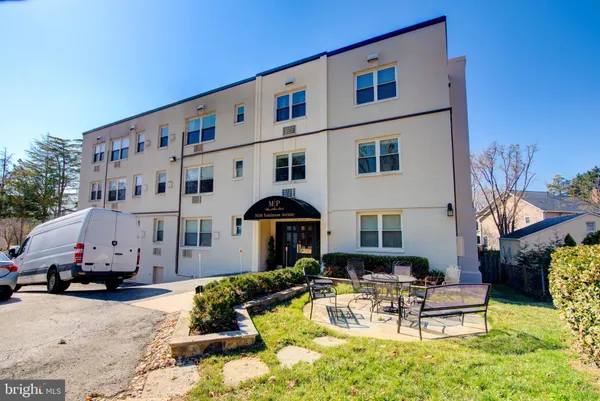 a view of a building with outdoor seating area
