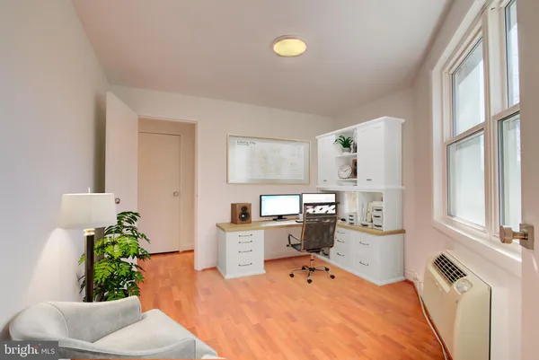 a bed room with a bed table chair and a window