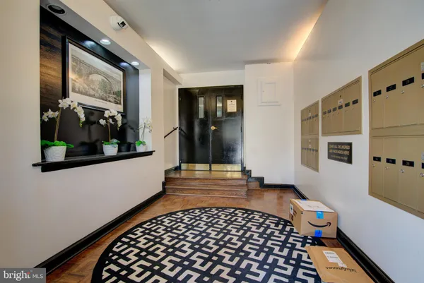 a view of a hallway with wooden floor and furniture