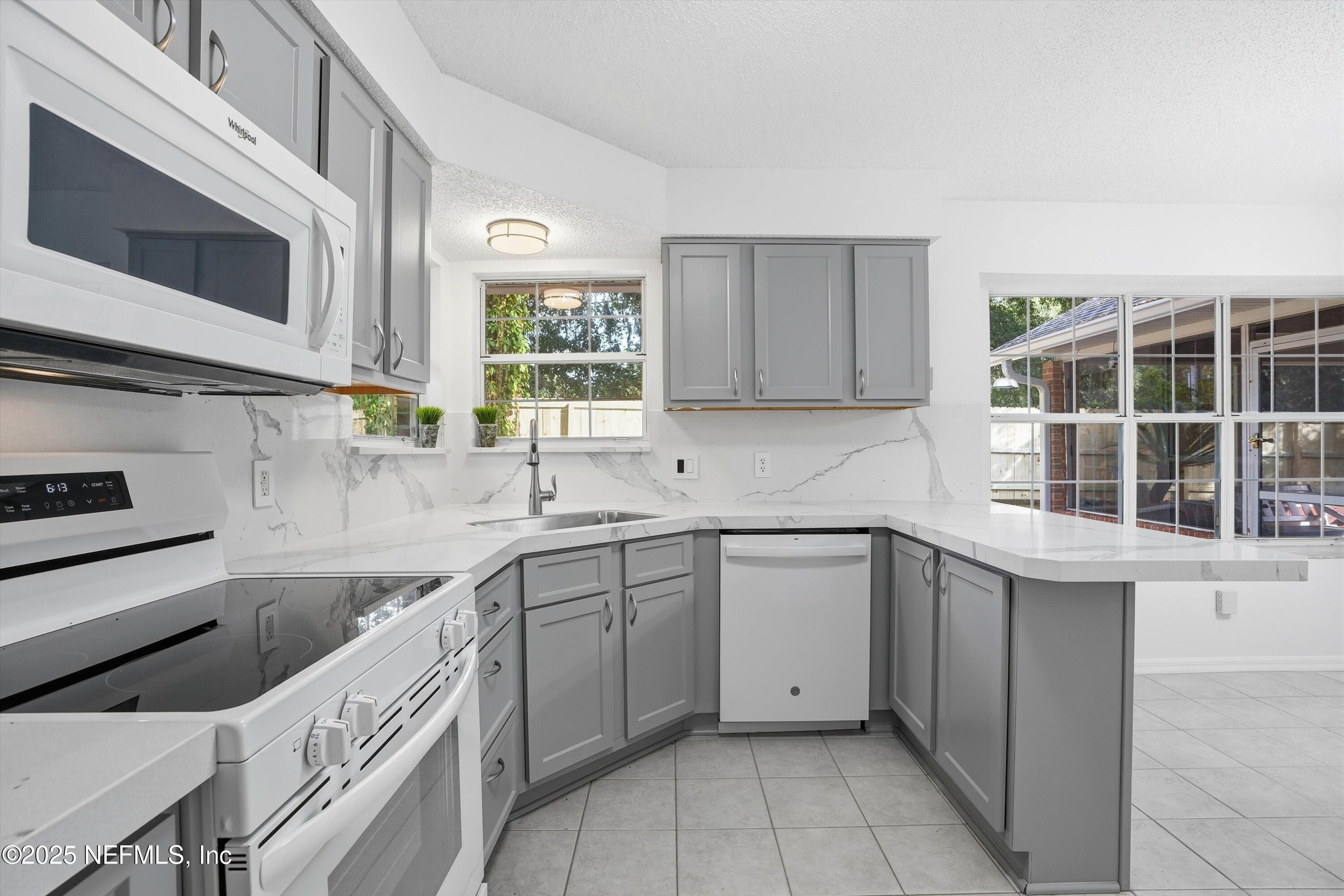 3297 Turtle Creek Road St. Augustine, FL 32086 - Photo 21 of 35 a kitchen with a sink and cabinets