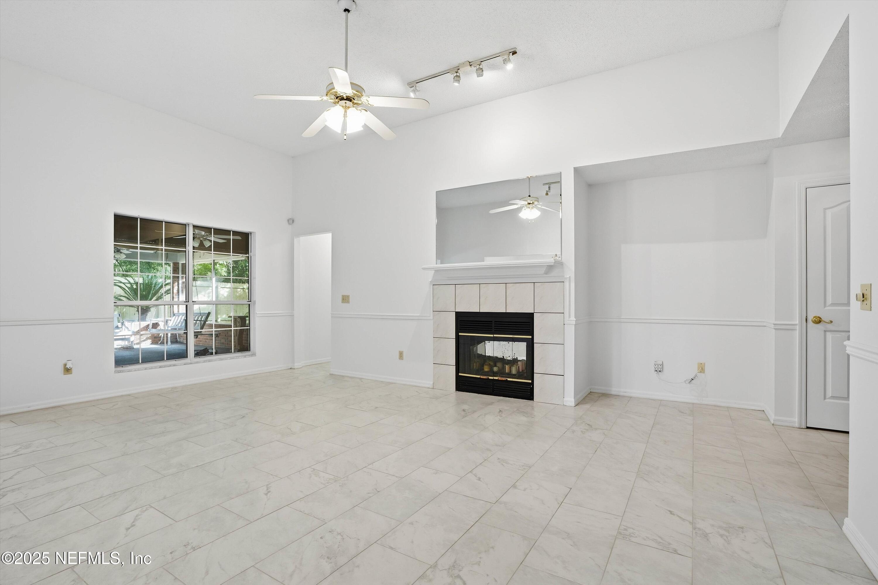 3297 Turtle Creek Road St. Augustine, FL 32086 - Photo 26 of 35 an empty room with windows and fireplace