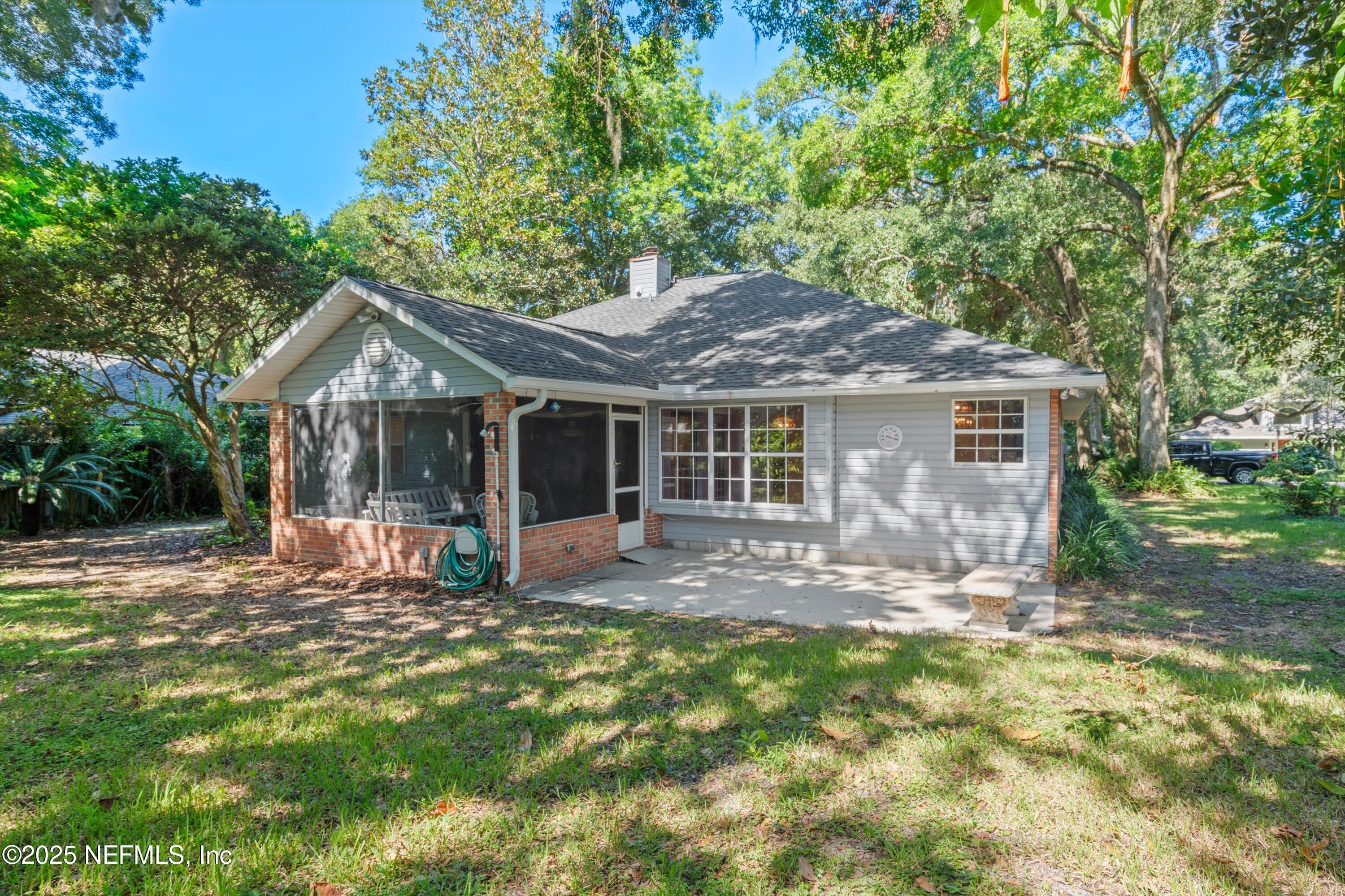 3297 Turtle Creek Road St. Augustine, FL 32086 - Photo 6 of 35 a backyard of a house with table and chairs