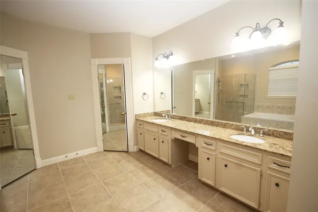 a spacious bathroom with a granite countertop sink mirror and double