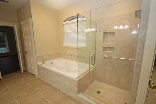a bathroom with a bathtub and a shower