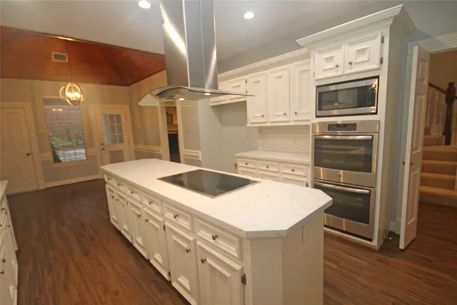 a kitchen with stainless steel appliances granite countertop a stove and a refrigerator