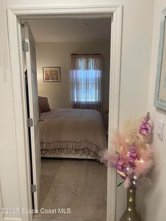 a bedroom with furniture and a potted plant