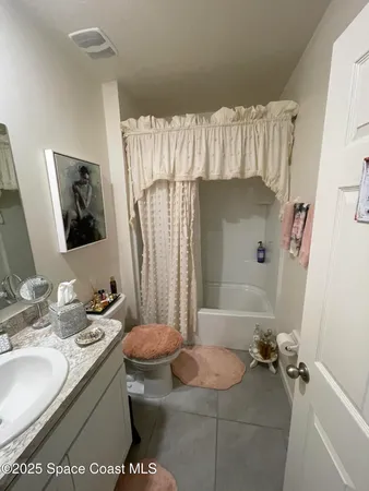 a bathroom with a sink vanity and mirror