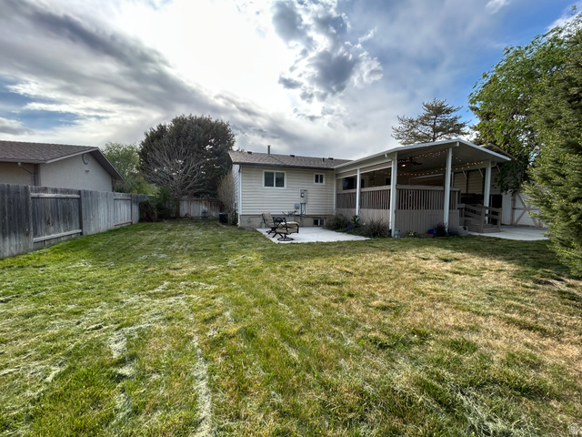 7659 State Street Midvale, UT 84047 - Photo 31 of 33 Back of property featuring a patio, a fenced backyard, a ceiling fan, and a sunroom