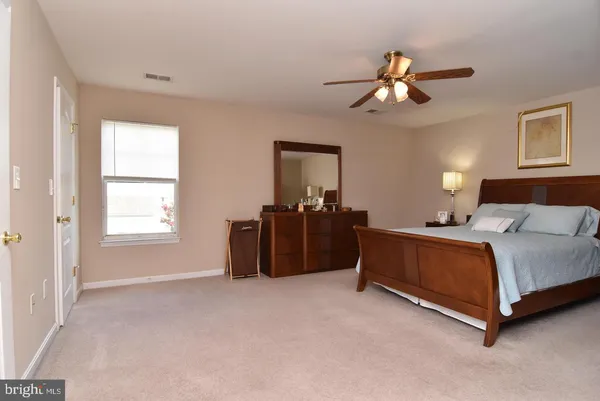 a bed room with a bed and a chandelier