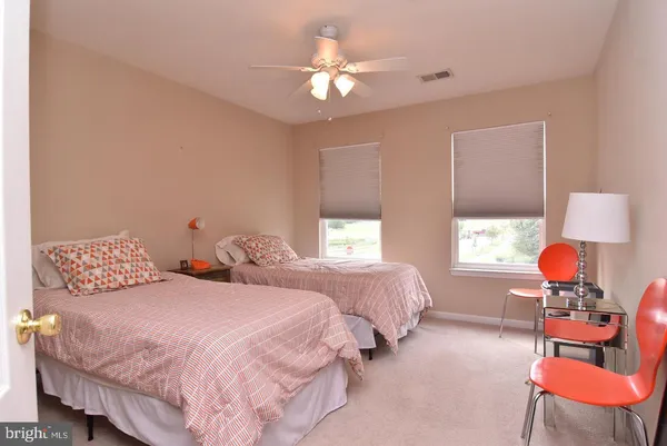 a bedroom with two beds and a chandelier