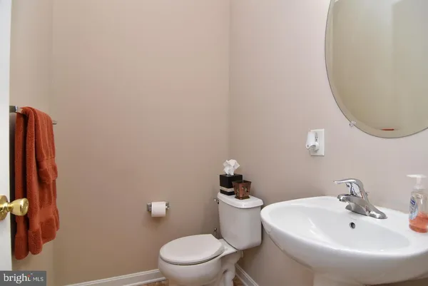 a white toilet sitting next to a bathroom sink