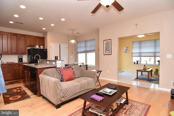 a living room with furniture and kitchen view