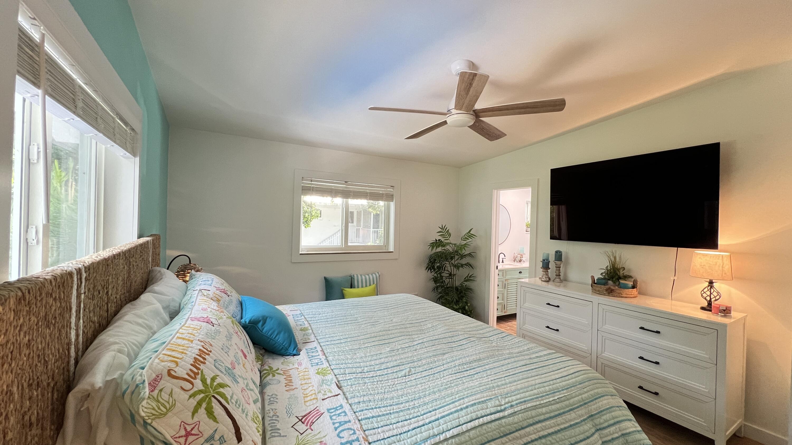 205 Sunset Boulevard Key Largo, FL 33037 - Photo 13 of 42 a bedroom with a large bed and a flat screen tv