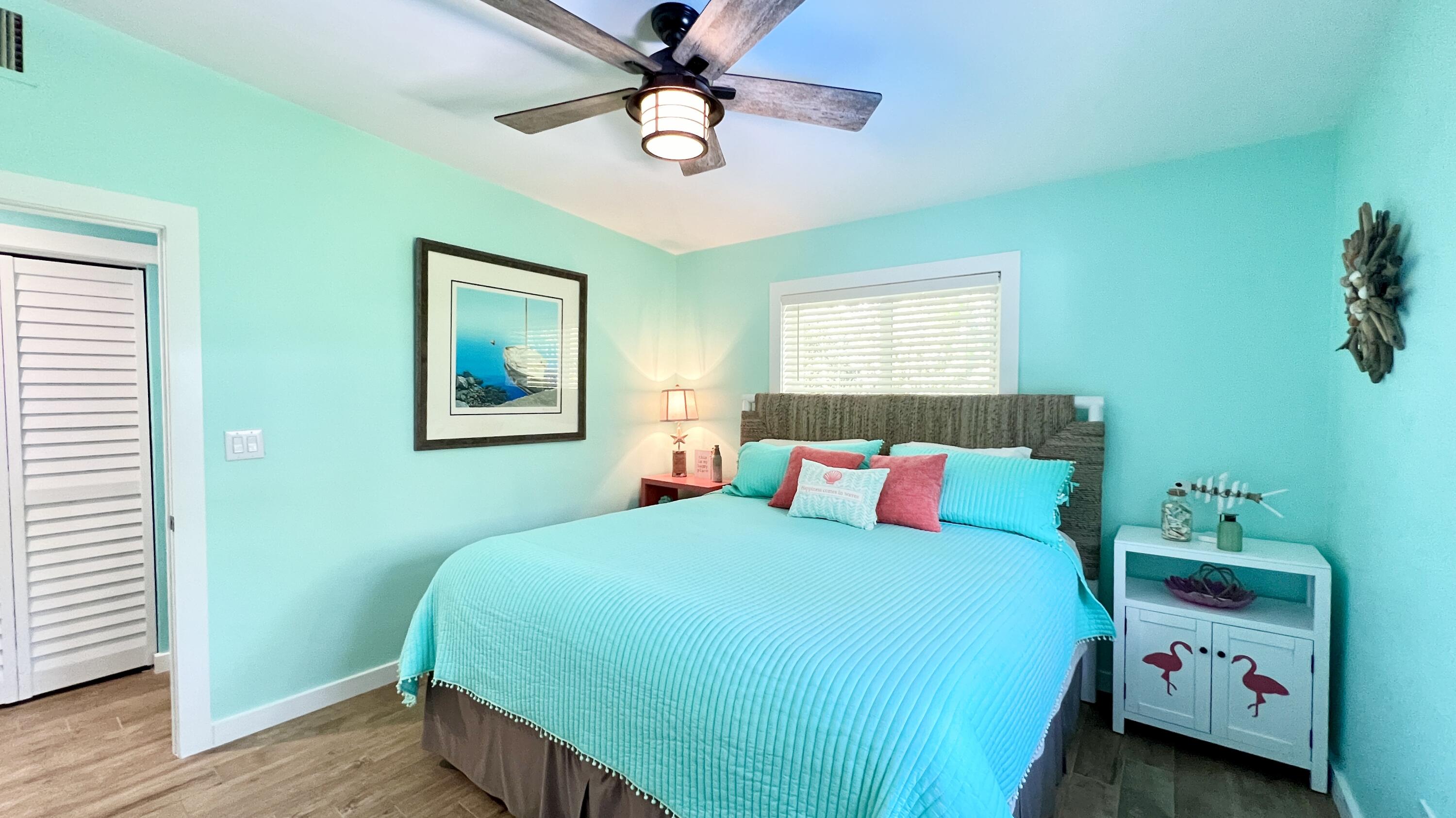 205 Sunset Boulevard Key Largo, FL 33037 - Photo 17 of 42 a bedroom with a bed and a chandelier