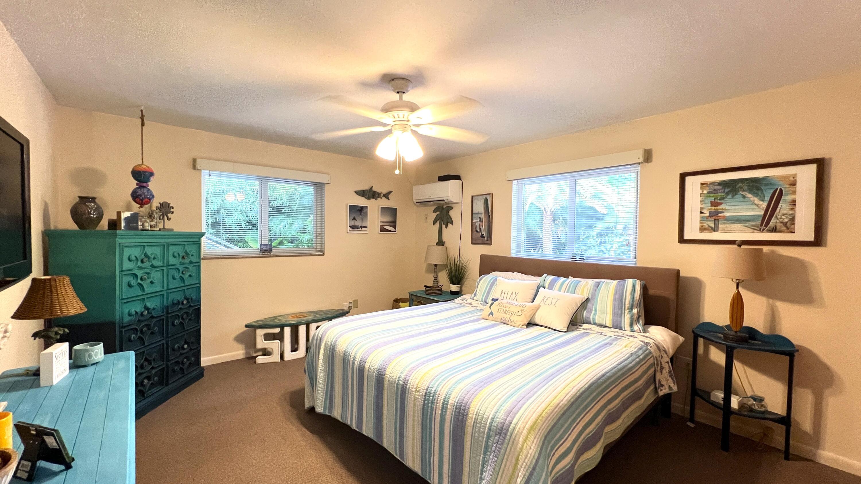 205 Sunset Boulevard Key Largo, FL 33037 - Photo 28 of 42 a bedroom with a bed a window and painting on the wall