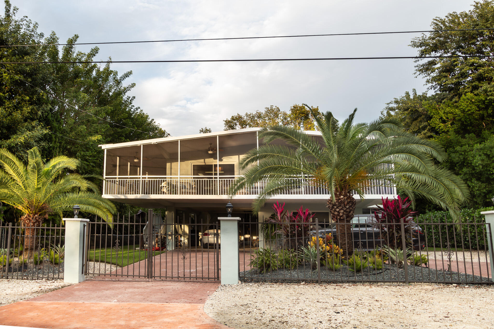 205 Sunset Boulevard Key Largo, FL 33037 - Photo 3 of 42 a front view of a house with a porch