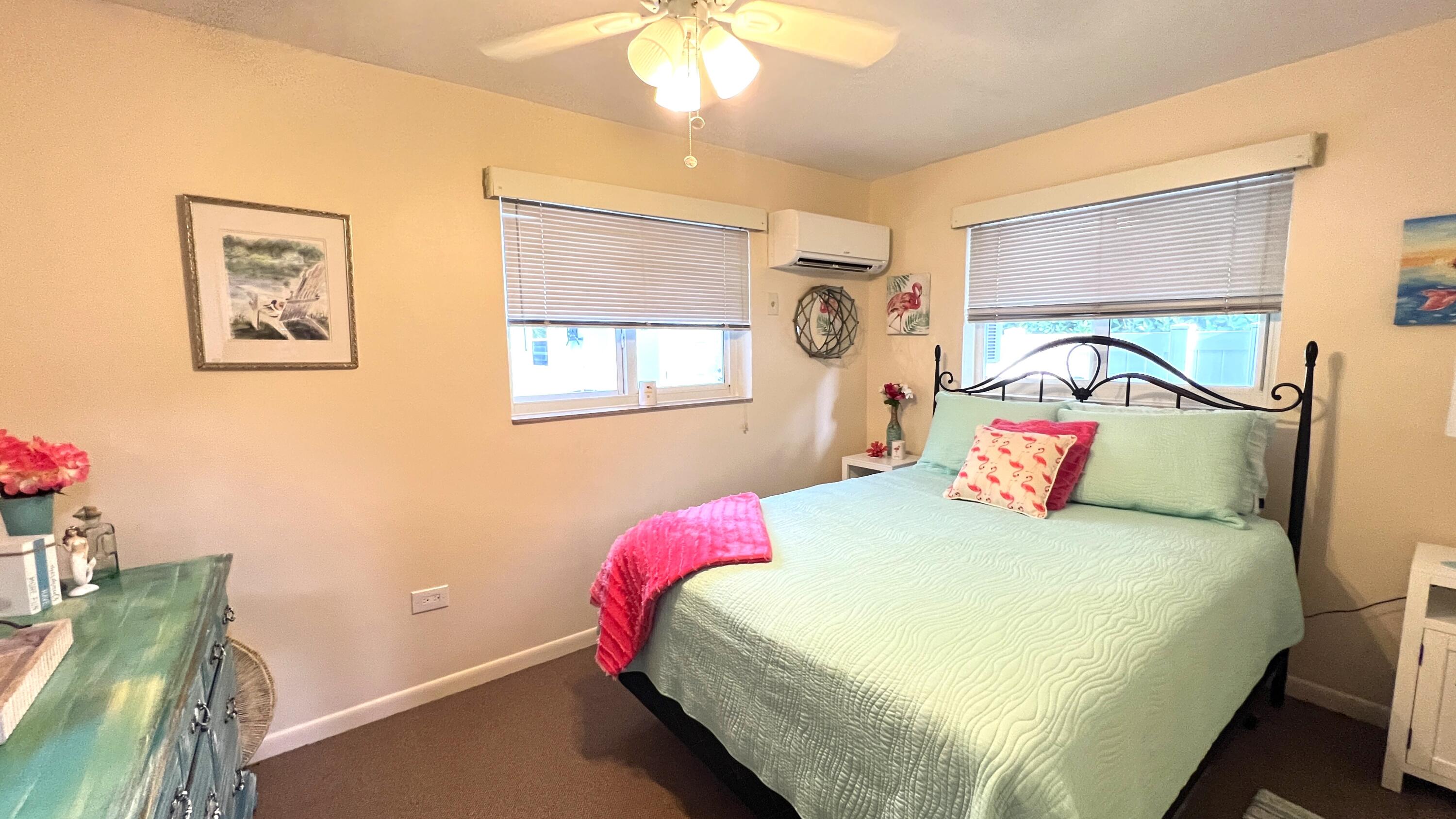 205 Sunset Boulevard Key Largo, FL 33037 - Photo 31 of 42 a bedroom with a bed and a chandelier