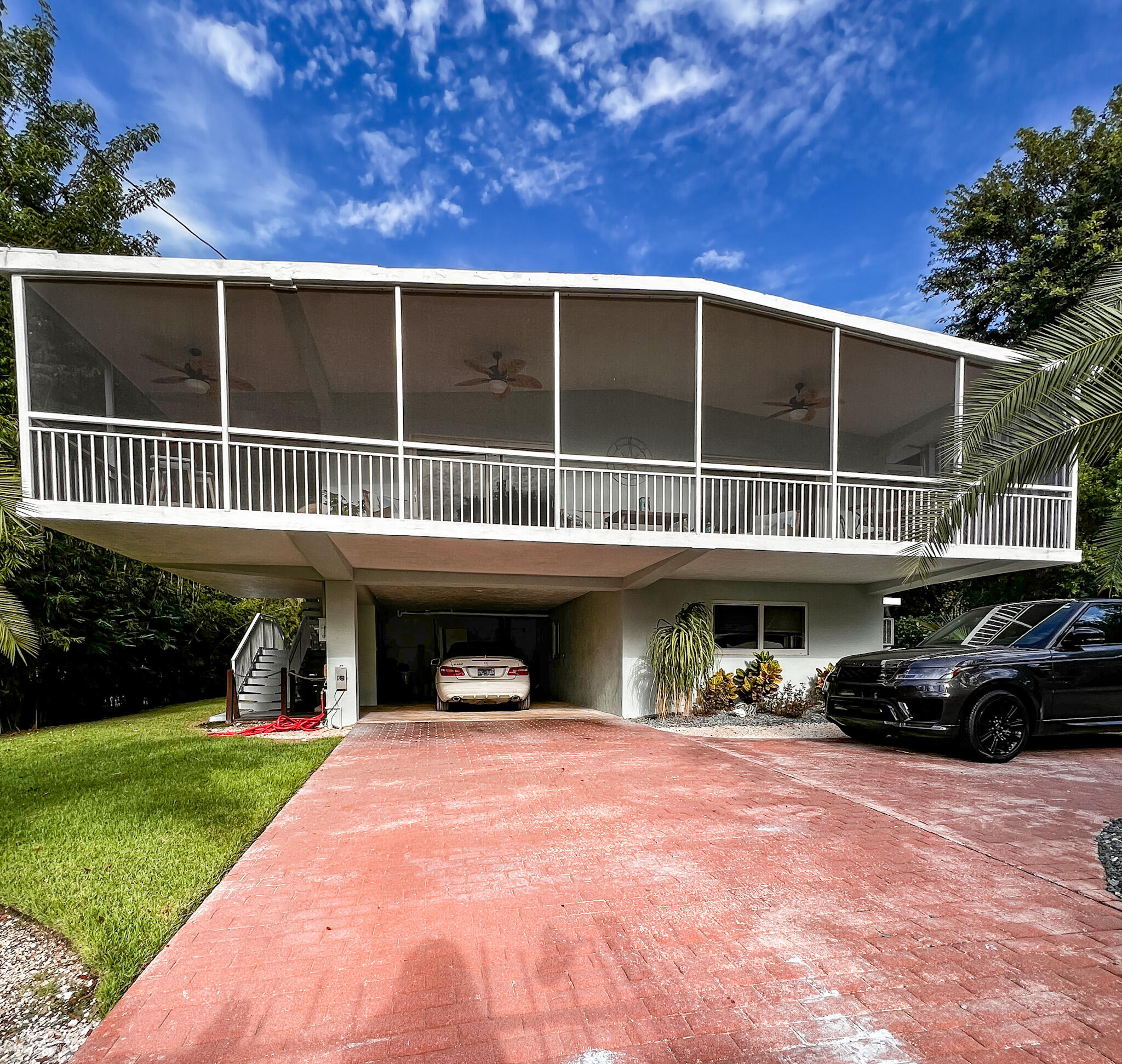 205 Sunset Boulevard Key Largo, FL 33037 - Photo 4 of 42 a view of a porch with furniture and garden