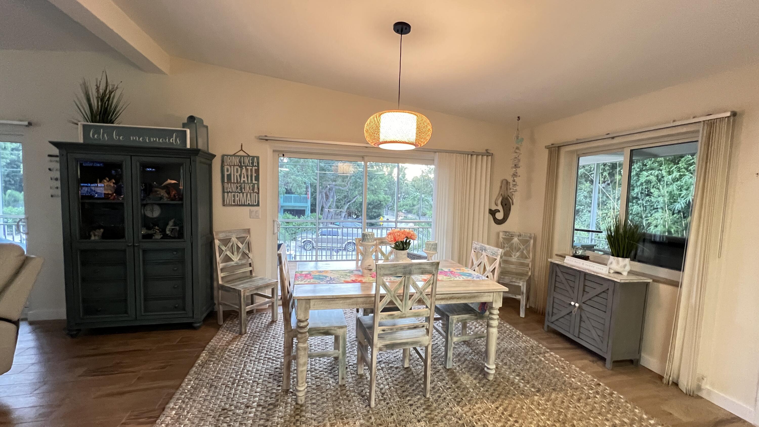205 Sunset Boulevard Key Largo, FL 33037 - Photo 5 of 42 a view of a dining room with furniture window and outside view
