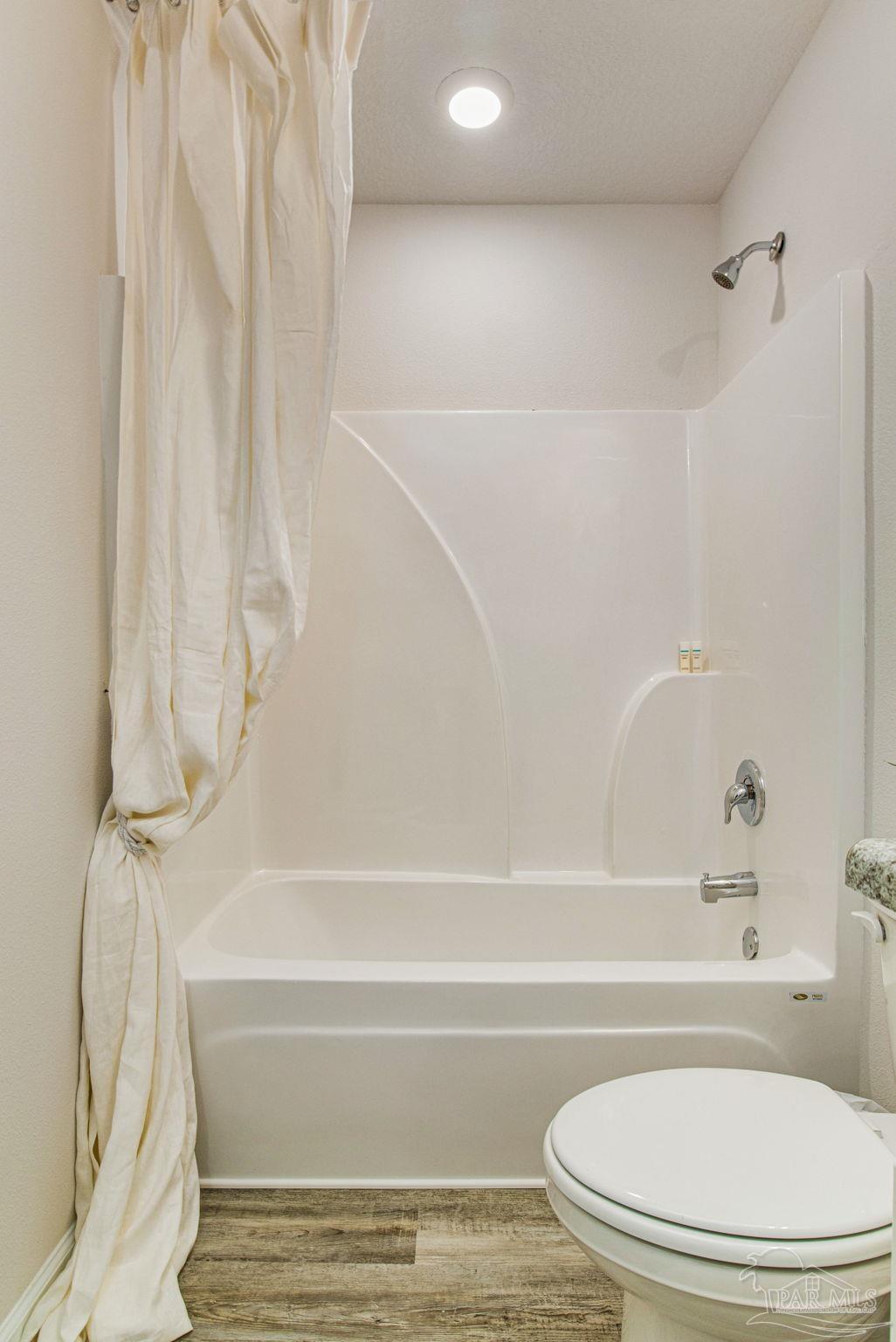 6461 Firefly Drive Milton, FL 32583 - Photo 23 of 36 a bathroom with a toilet and a bathtub