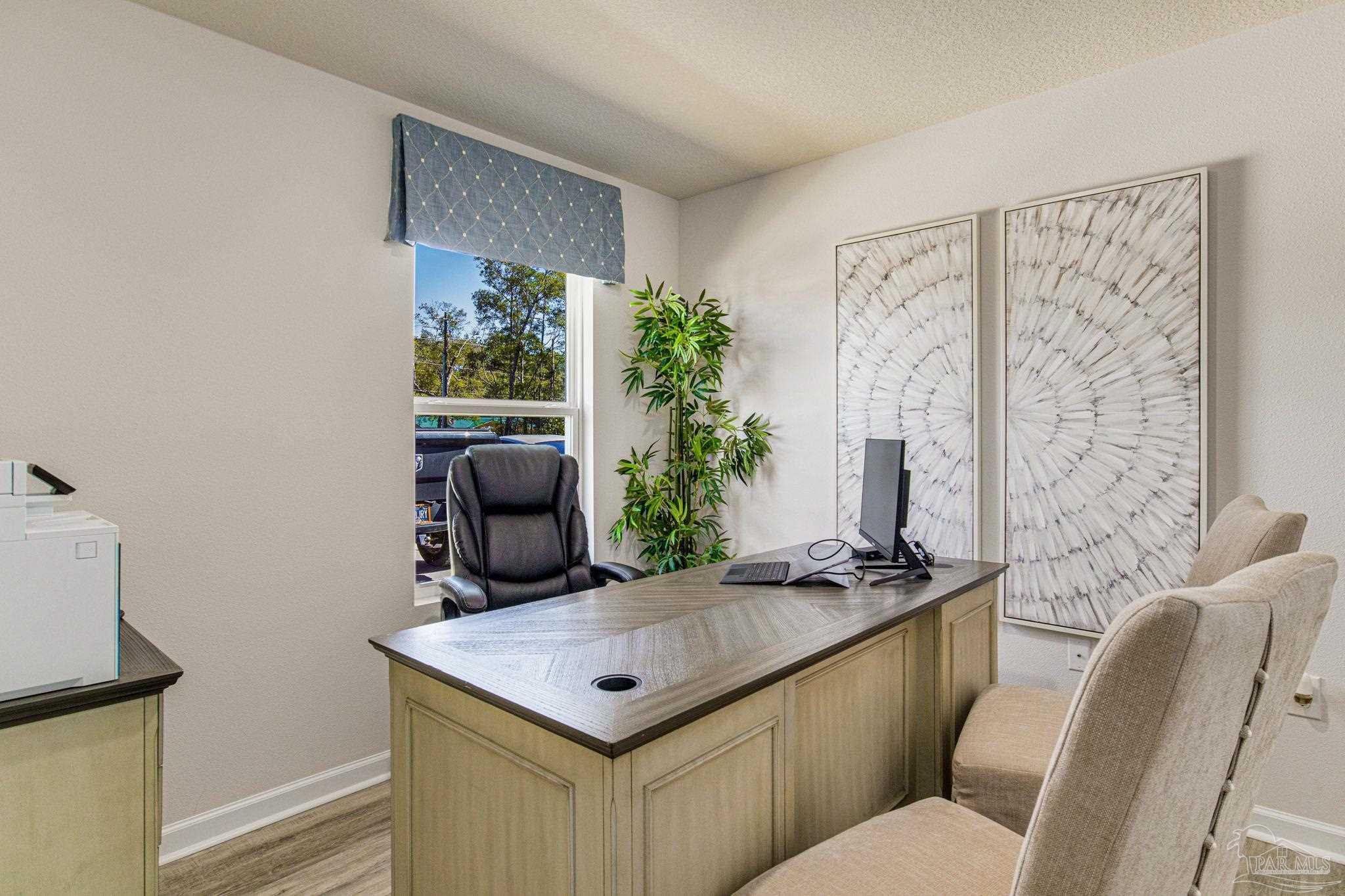 6461 Firefly Drive Milton, FL 32583 - Photo 26 of 36 a view of a room that has a couch and a potted plant in a bathroom