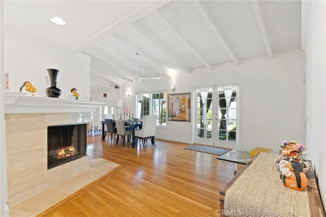 a living room with furniture and fireplace with wooden floor