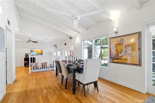 a dining room with furniture and wooden floor