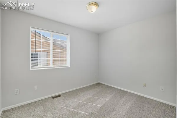 a bedroom with a bed and a potted plant