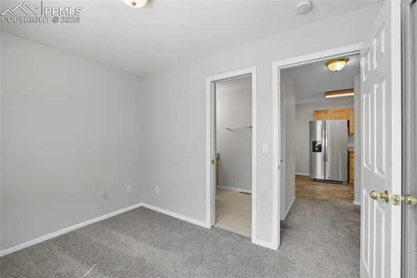 a view of an empty room with closet area
