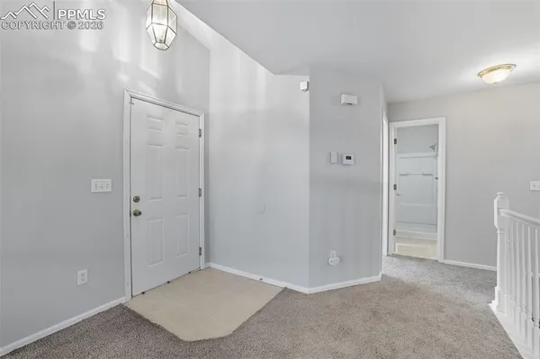 a view of a hallway with closet and entryway