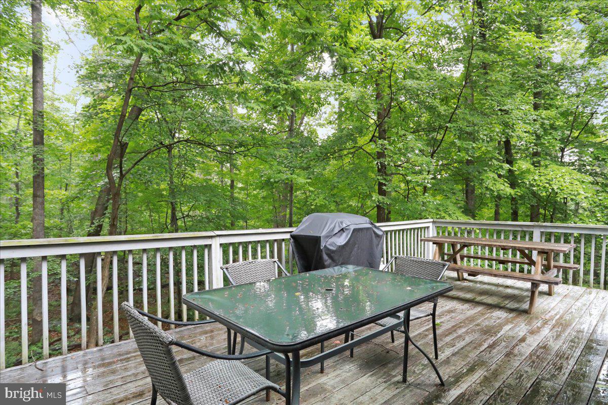 13 Mountainside Loop Berkeley Springs, WV 25411 - Photo 14 of 57 a view of a deck with a table and chairs