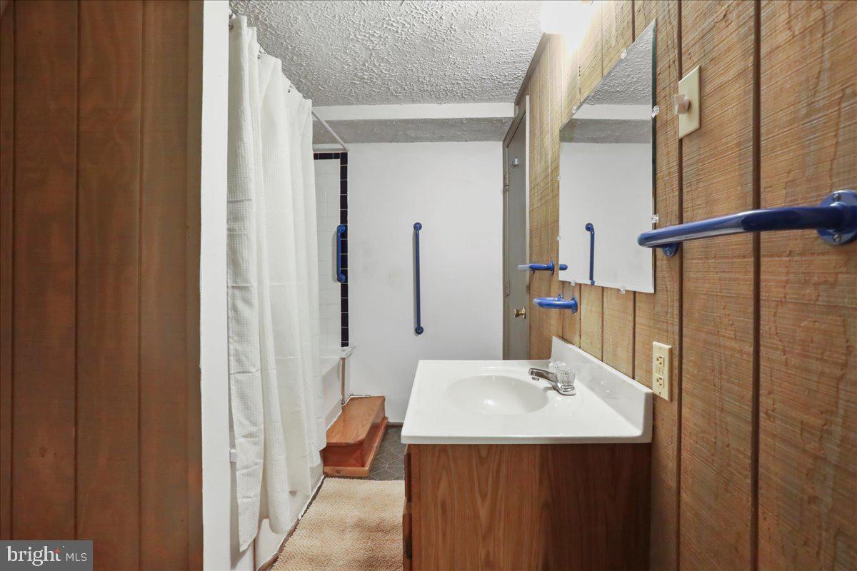 13 Mountainside Loop Berkeley Springs, WV 25411 - Photo 19 of 57 a bathroom with a sink and a mirror