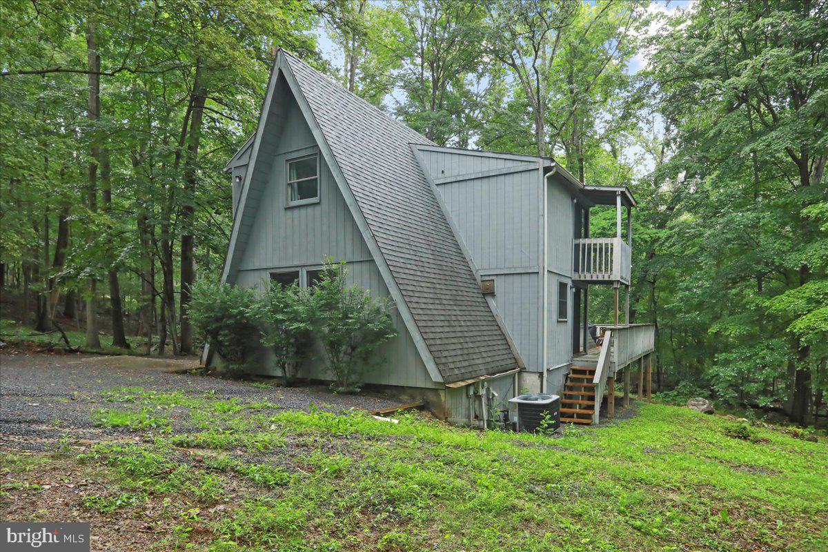 13 Mountainside Loop Berkeley Springs, WV 25411 - Photo 2 of 57 a view of backyard with small cabin and wooden fence