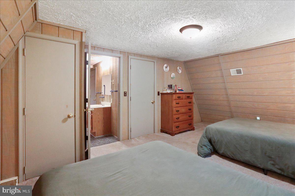 13 Mountainside Loop Berkeley Springs, WV 25411 - Photo 21 of 57 a bedroom with a bed and a cabinets