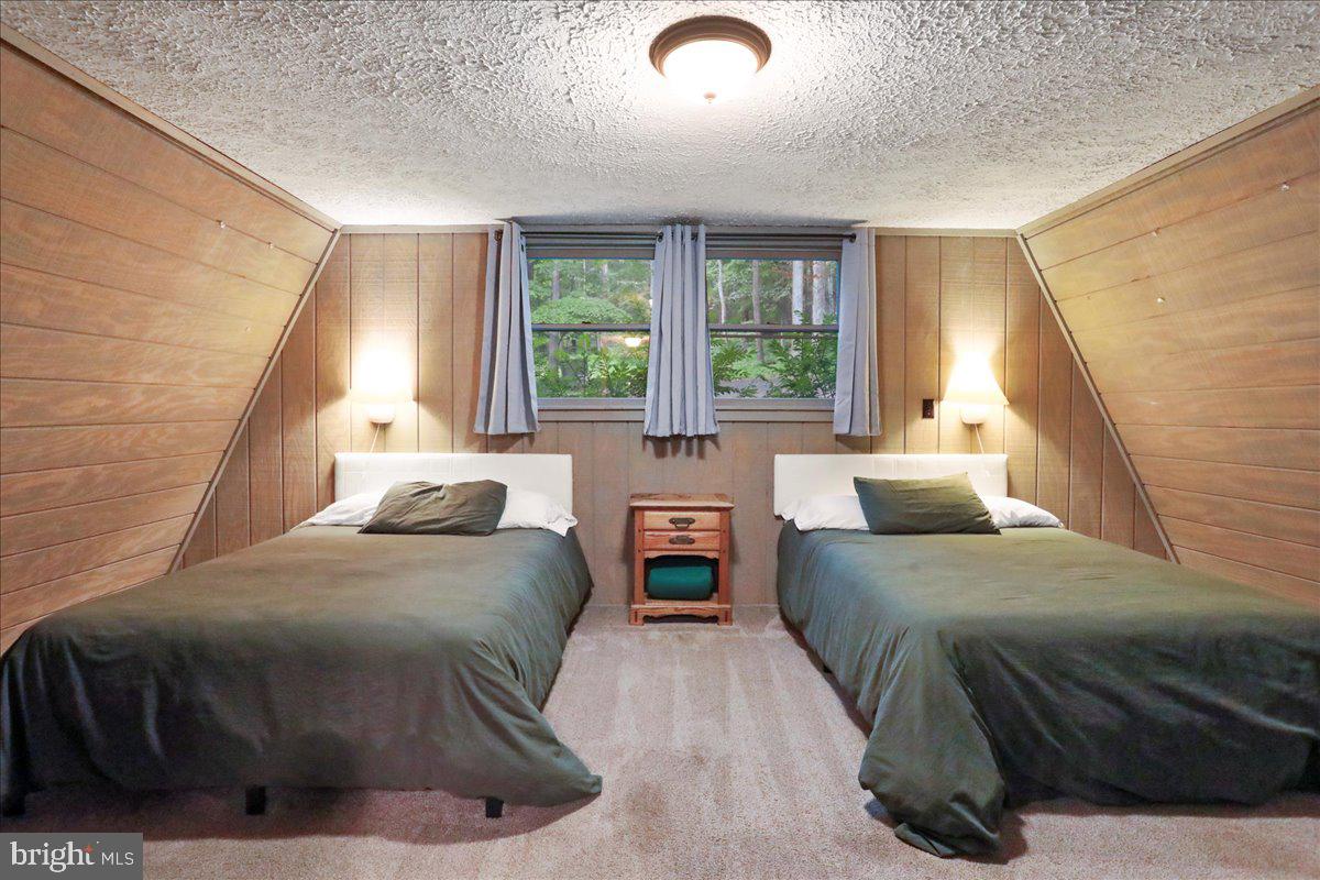 13 Mountainside Loop Berkeley Springs, WV 25411 - Photo 22 of 57 a bedroom with a bed and a large window