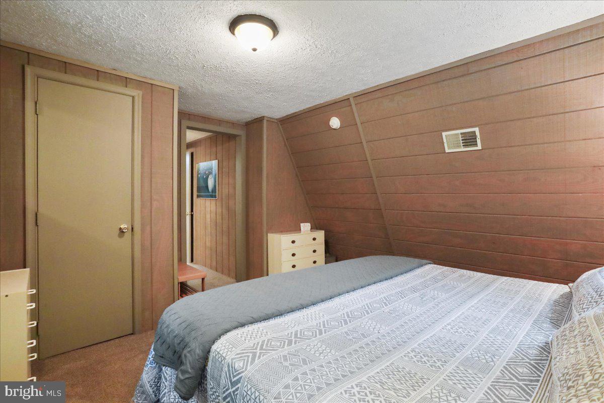 13 Mountainside Loop Berkeley Springs, WV 25411 - Photo 27 of 57 a bedroom with a bed and a mirror