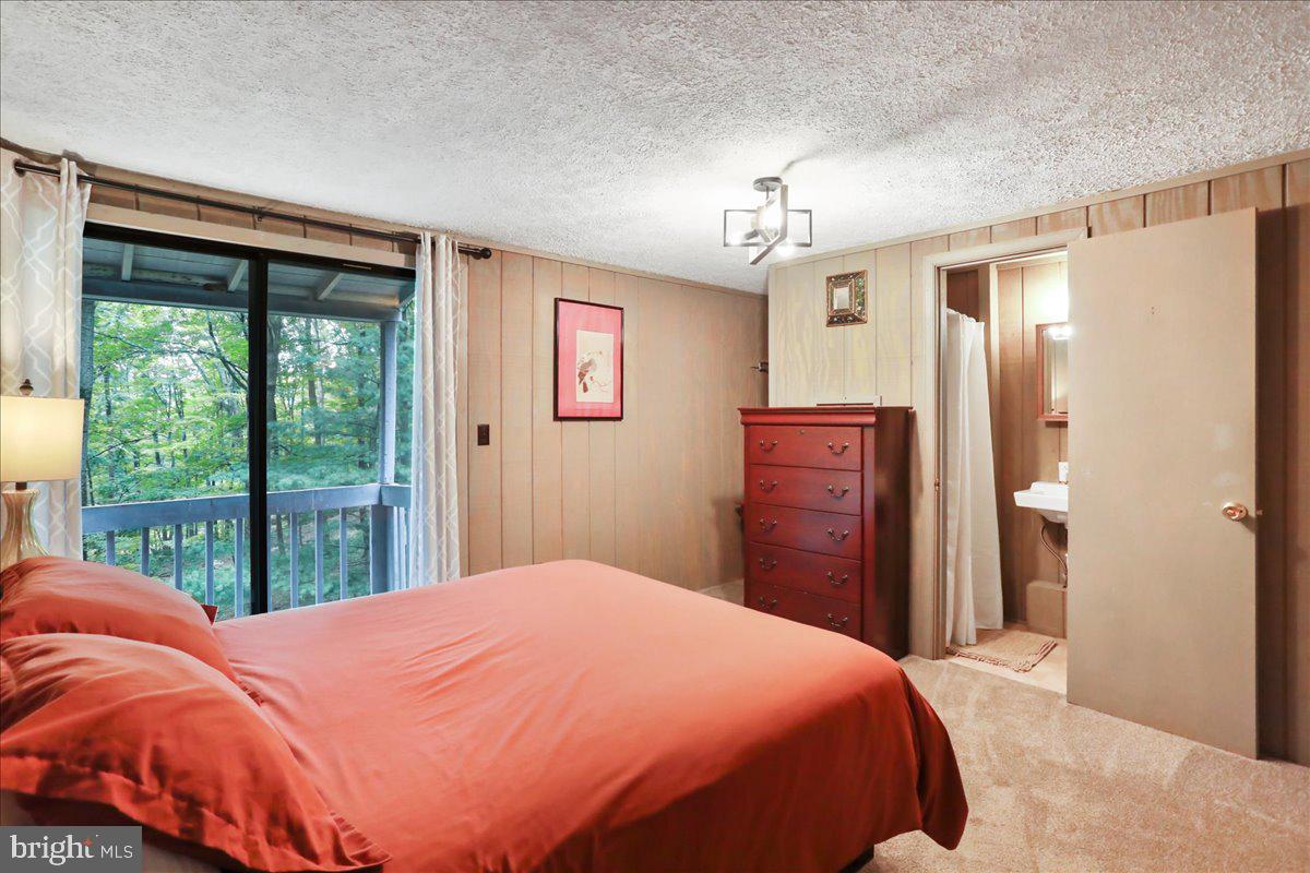 13 Mountainside Loop Berkeley Springs, WV 25411 - Photo 33 of 57 a bedroom with a bed dresser and a window