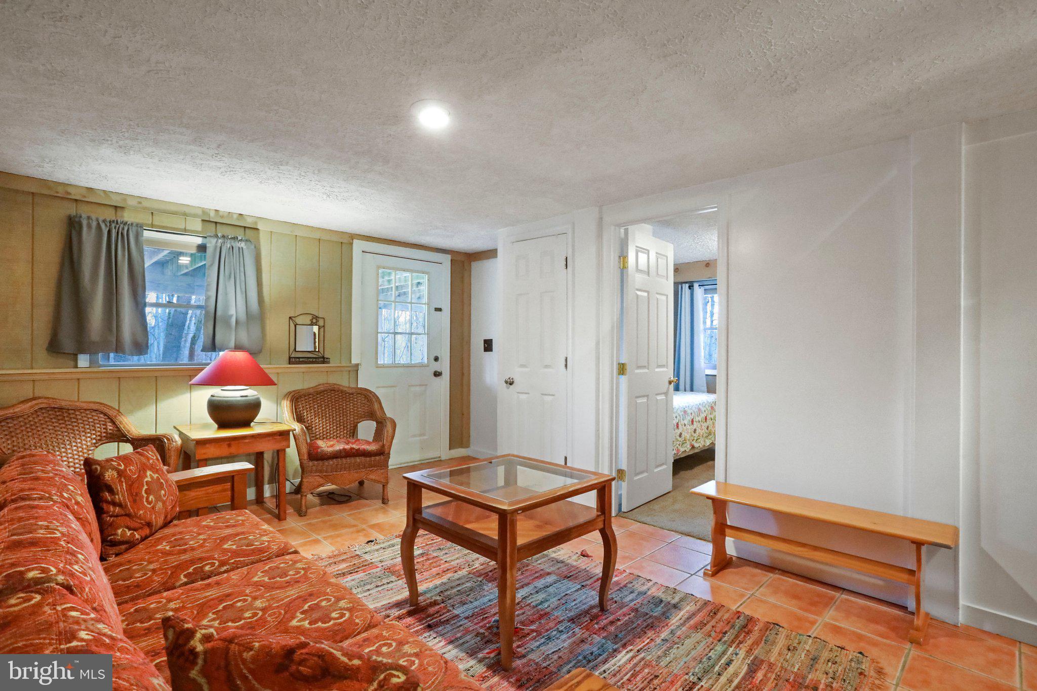 13 Mountainside Loop Berkeley Springs, WV 25411 - Photo 42 of 57 a living room with furniture a rug and a window