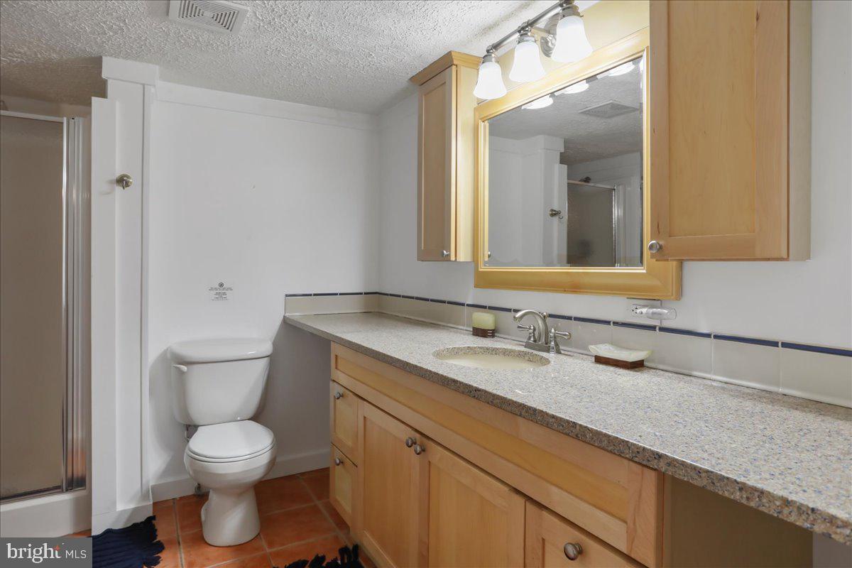 13 Mountainside Loop Berkeley Springs, WV 25411 - Photo 44 of 57 a bathroom with a granite countertop toilet sink and mirror