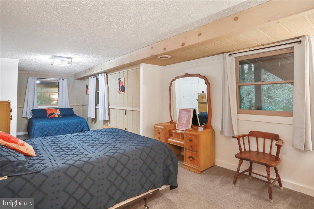 13 Mountainside Loop Berkeley Springs, WV 25411 - Photo 46 of 57 a bedroom with a large bed and wooden floor