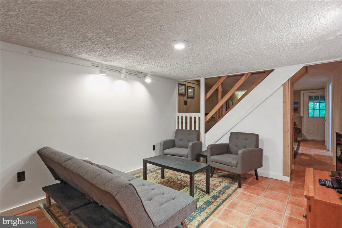 13 Mountainside Loop Berkeley Springs, WV 25411 - Photo 47 of 57 a living room with furniture and a stairs