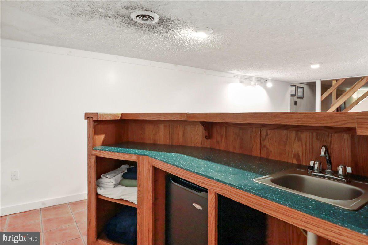 13 Mountainside Loop Berkeley Springs, WV 25411 - Photo 54 of 57 a kitchen with a sink and cabinets
