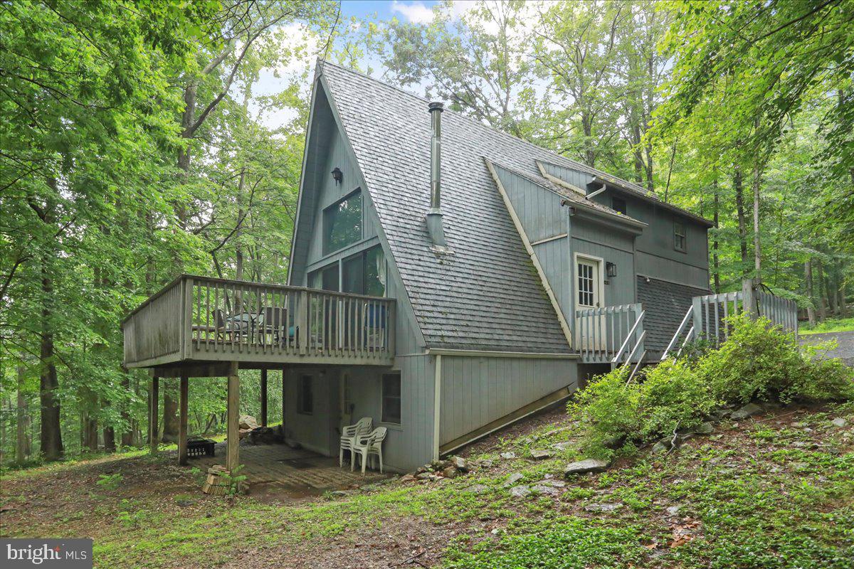 13 Mountainside Loop Berkeley Springs, WV 25411 - Photo 56 of 57 a backyard of a house with lots of green space