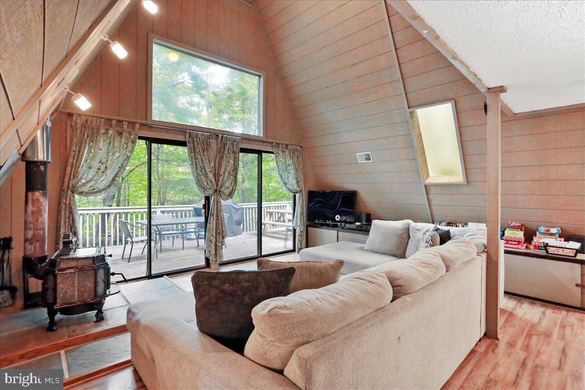 13 Mountainside Loop Berkeley Springs, WV 25411 - Photo 9 of 57 a living room with furniture a flat screen tv and a large window